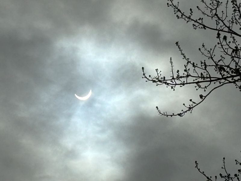 Solar eclipse behind clouds